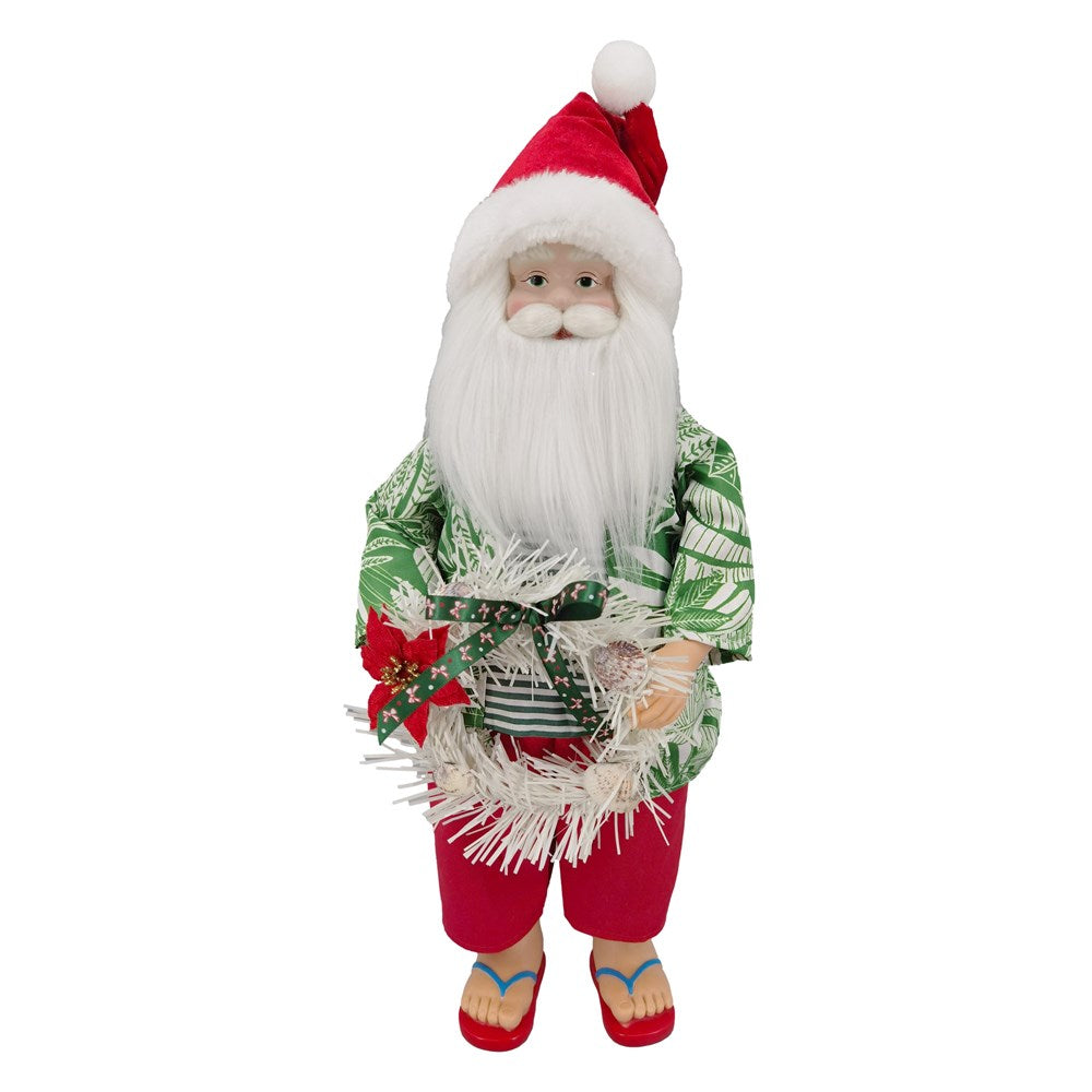 Standing Santa in a tropical shirt, red shorts and jandals holding a shell and poinsettia wreath