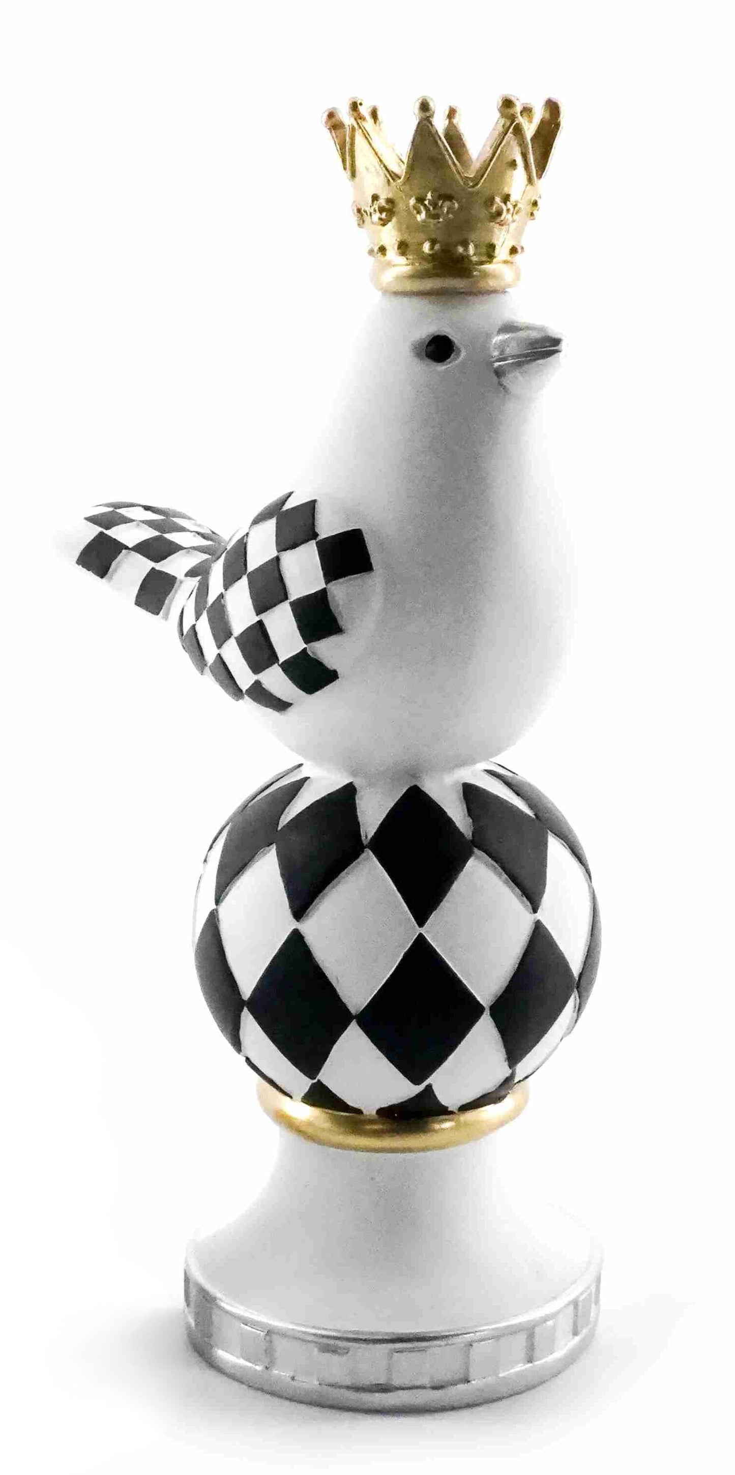 White bird figurine with black checkered pattern and gold crown on a black and white harlequin sphere