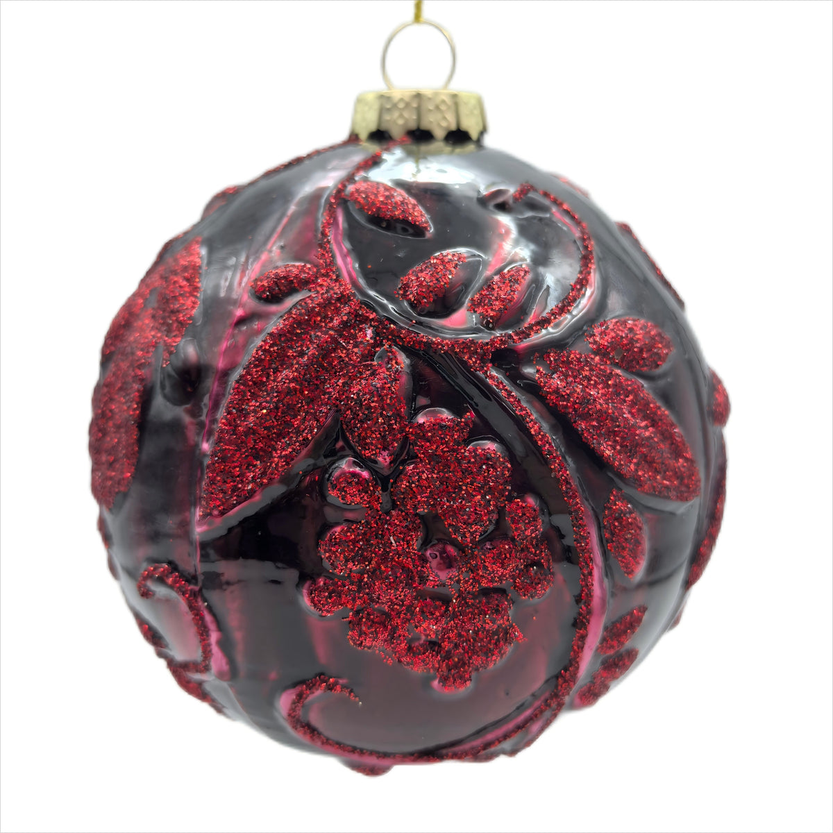 Burgundy berry glass bauble with raised red glitter floral and scrollwork design and gold cap