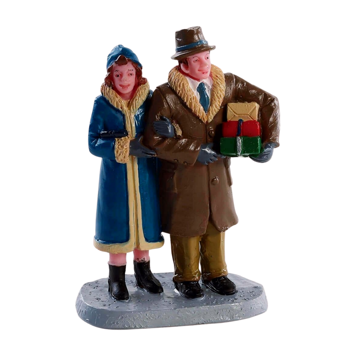 Lemax miniature couple figurine in winter coats — woman in blue, man in brown holding wrapped Christmas gifts