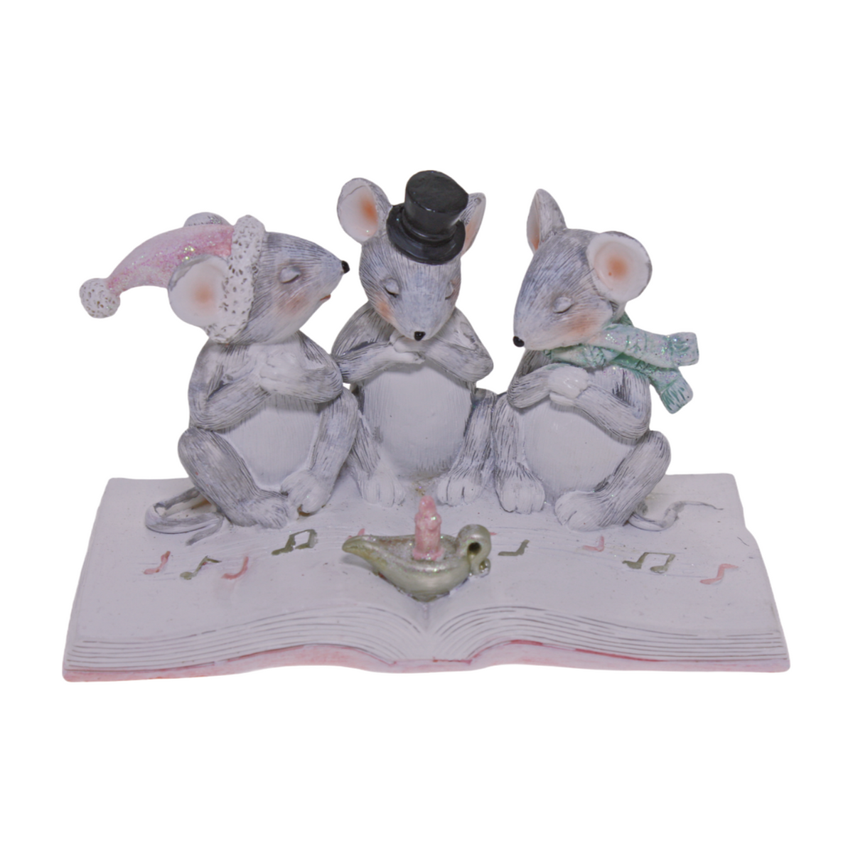 Three Christmas mice wearing pastel winter accessories sitting on an open book with a candle in front