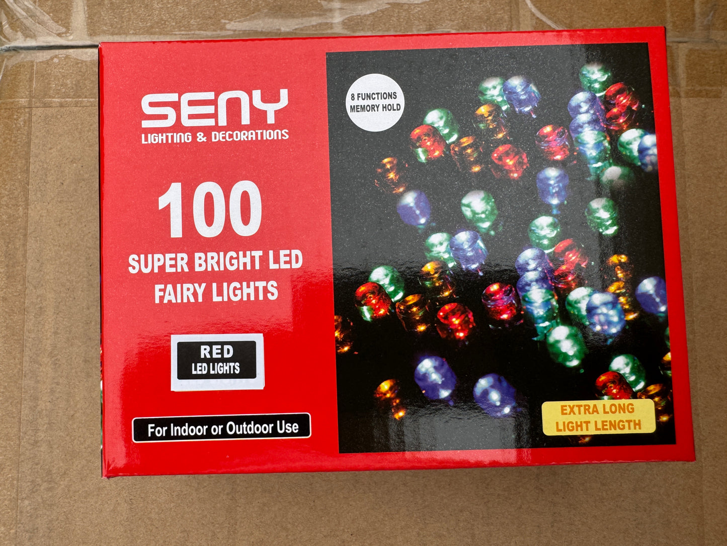 Box of SENY LED fairy lights with red packaging on a cardboard background