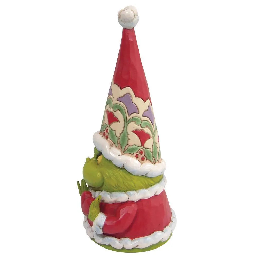 Right side view of a Grinch gnome figurine, green hands visible beneath a tall holly-patterned red Santa hat