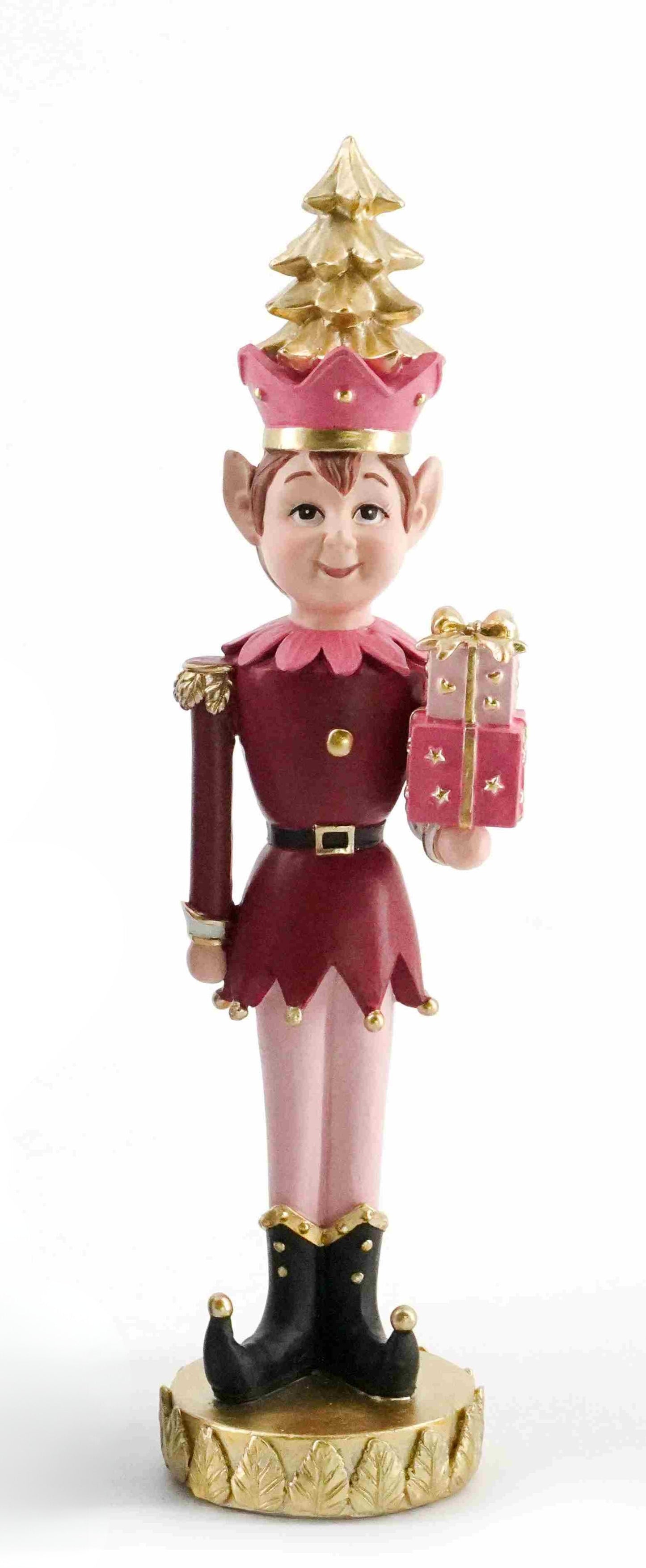 Festive pink and gold Christmas elf figurine holding a present with a golden tree hat