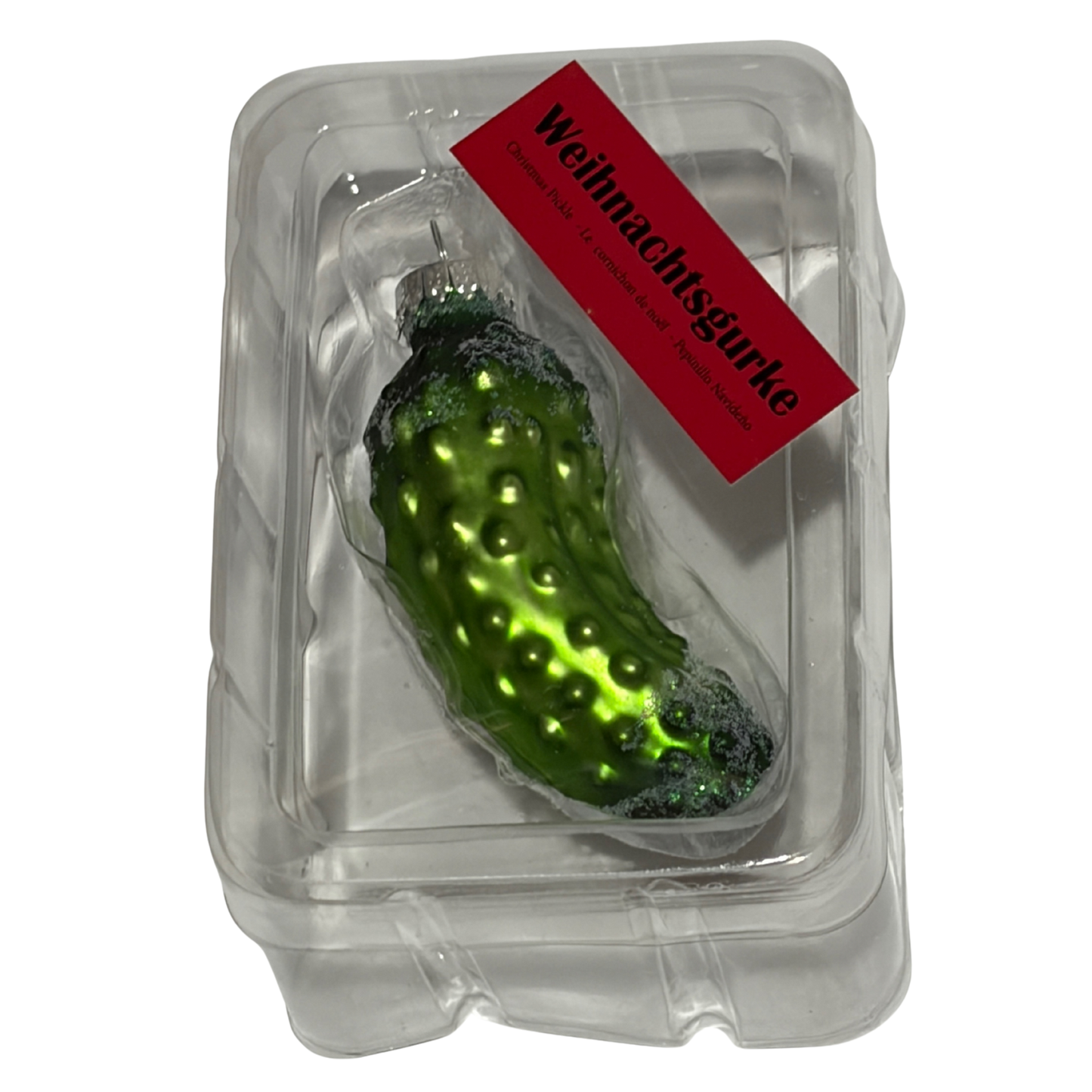 Decorative pickle ornament in a clear packaging with a red label on a white background