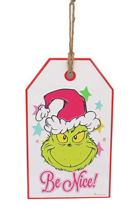 Door hanger featuring the Grinch wearing a Santa hat with colourful stars and the words “Be Nice!”