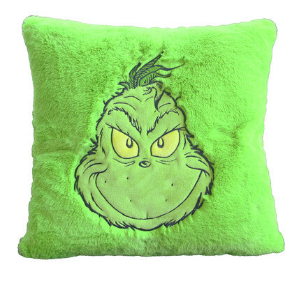 Bright green plush cushion with embroidered Grinch face showing a cheeky grin