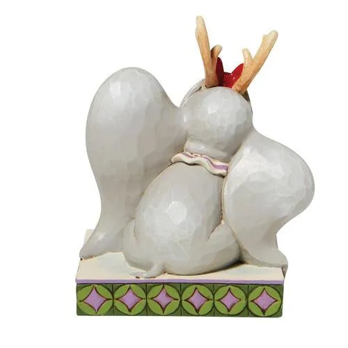 Rear view of Dumbo Christmas figurine wearing reindeer antlers and a red bow, large ears spread wide on a patterned base