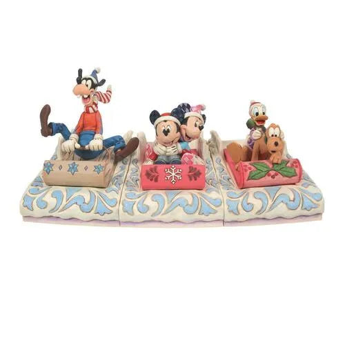 Three-piece Disney Christmas sledding figurine set: Goofy, Mickey and Minnie, and Donald with Pluto, each on a folk art sled base
