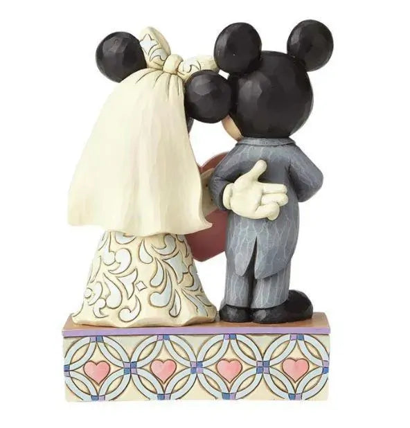 Mickey and Minnie Mouse wedding figurine rear view, Minnie in scrollwork gown with veil, Mickey in suit, on a heart pattern base