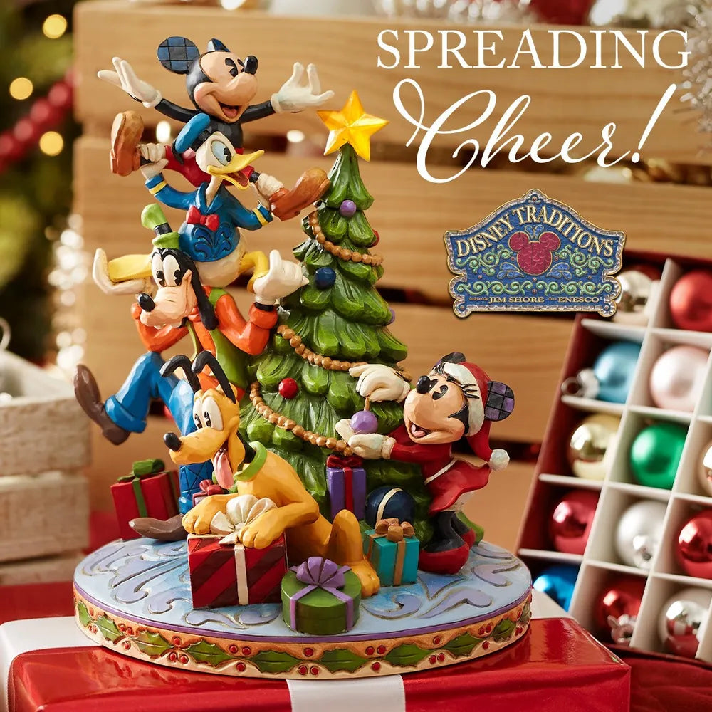 Disney Traditions Fab Five Christmas tree figurine displayed in a festive setting with ornaments and wrapped gifts nearby.