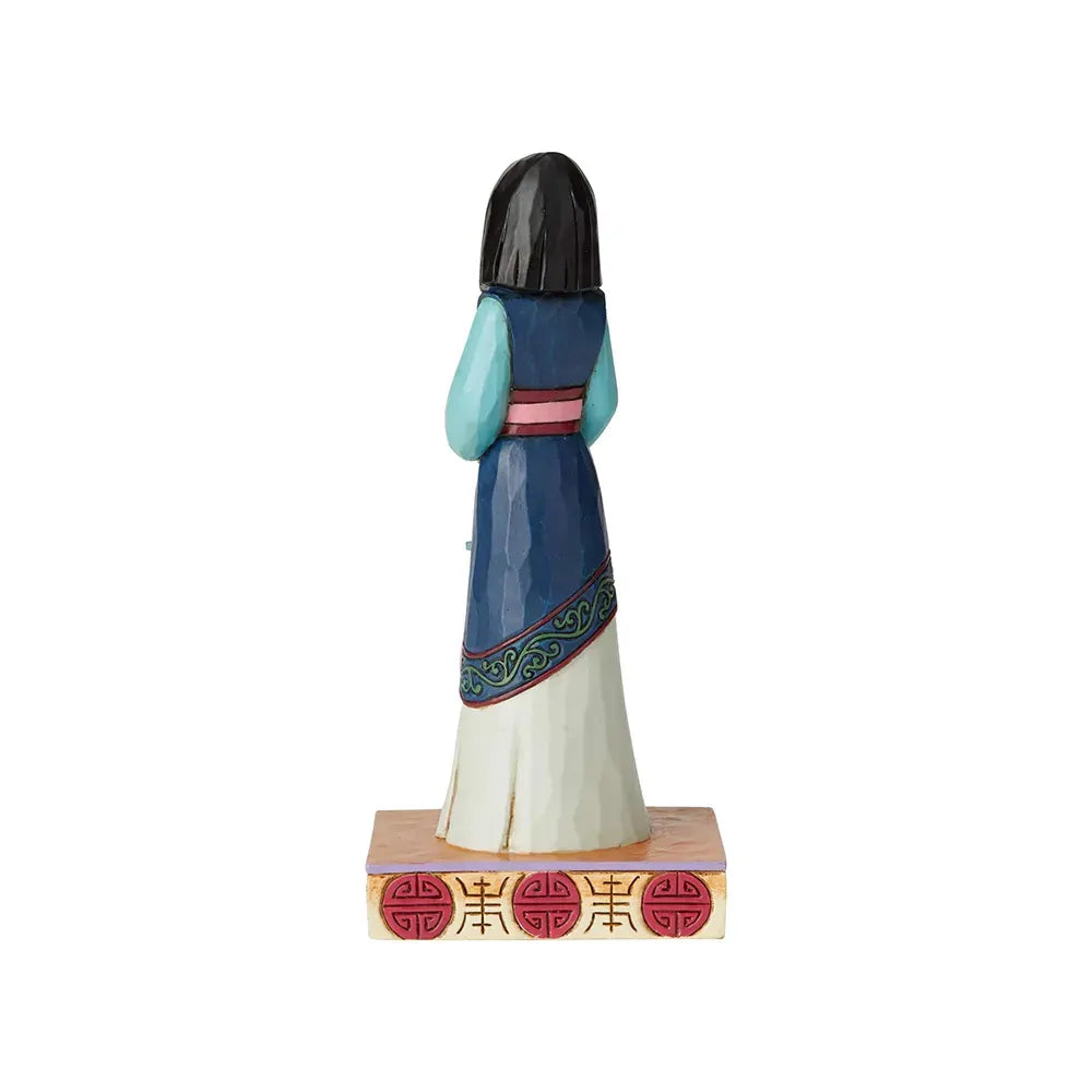 Mulan figurine rear view showing blue robe with green scrollwork border detail, on a red Chinese symbol painted base