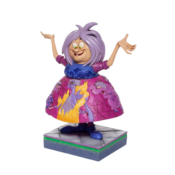 Madam Mim figurine viewed from angled right front, arms raised, skirt decorated with cats and flame imagery, on tiled base