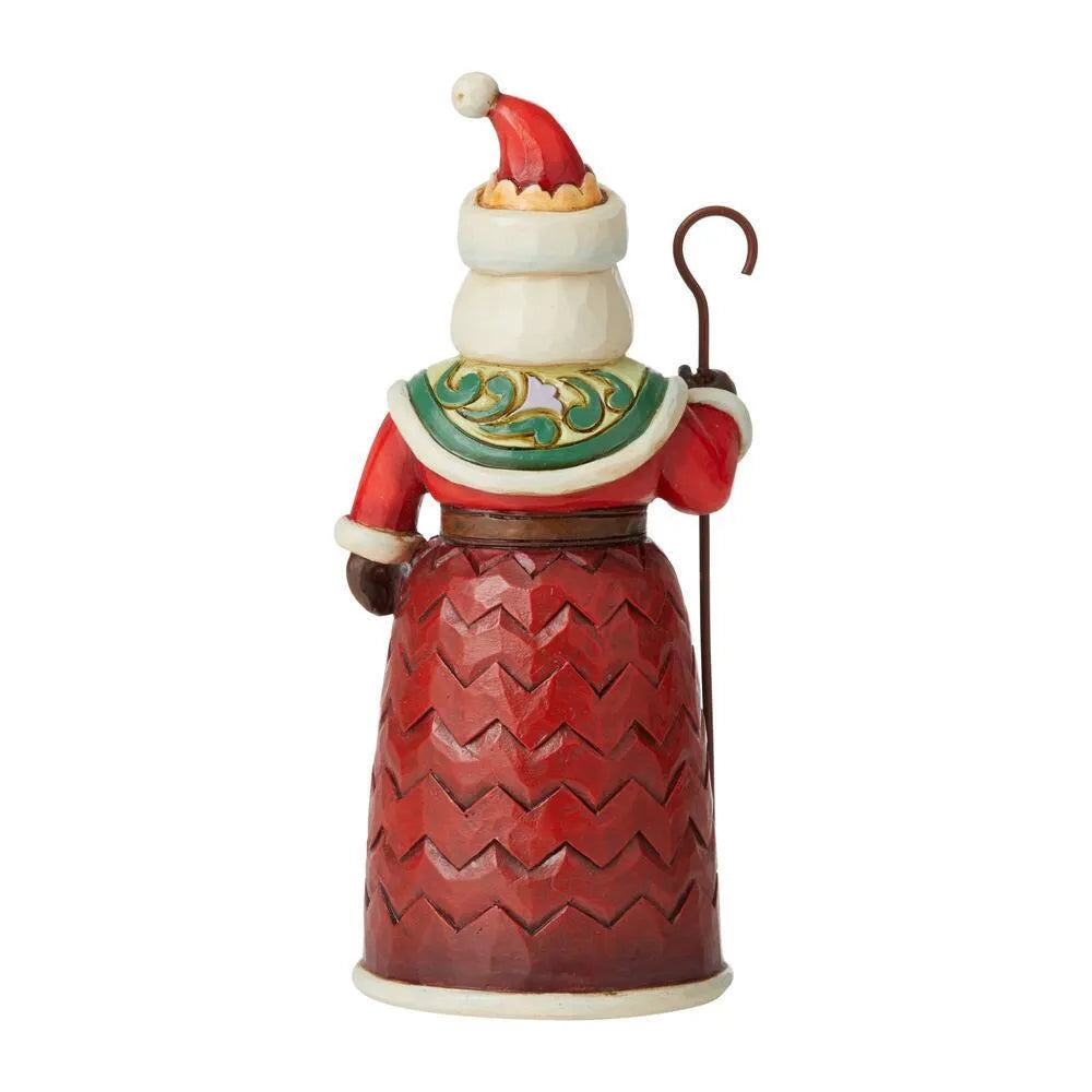 Rear view of a Santa figurine with a shepherd's crook, chevron-patterned robe and green scrollwork collar detail.