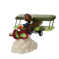 Jim Shore Peanuts Snoopy Flying Ace figurine piloting a red and green biplane above clouds