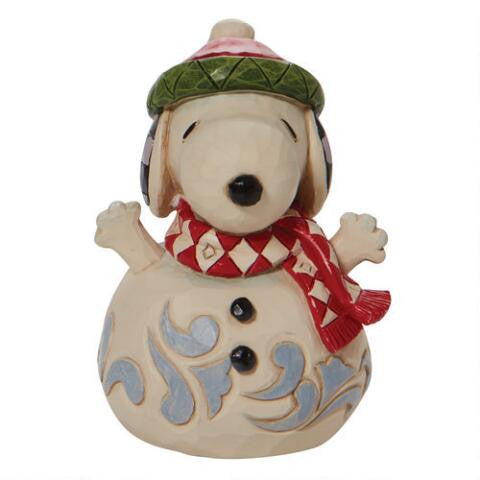 Front view of Jim Shore Peanuts Snoopy snowman figurine with raised paws and festive scarf