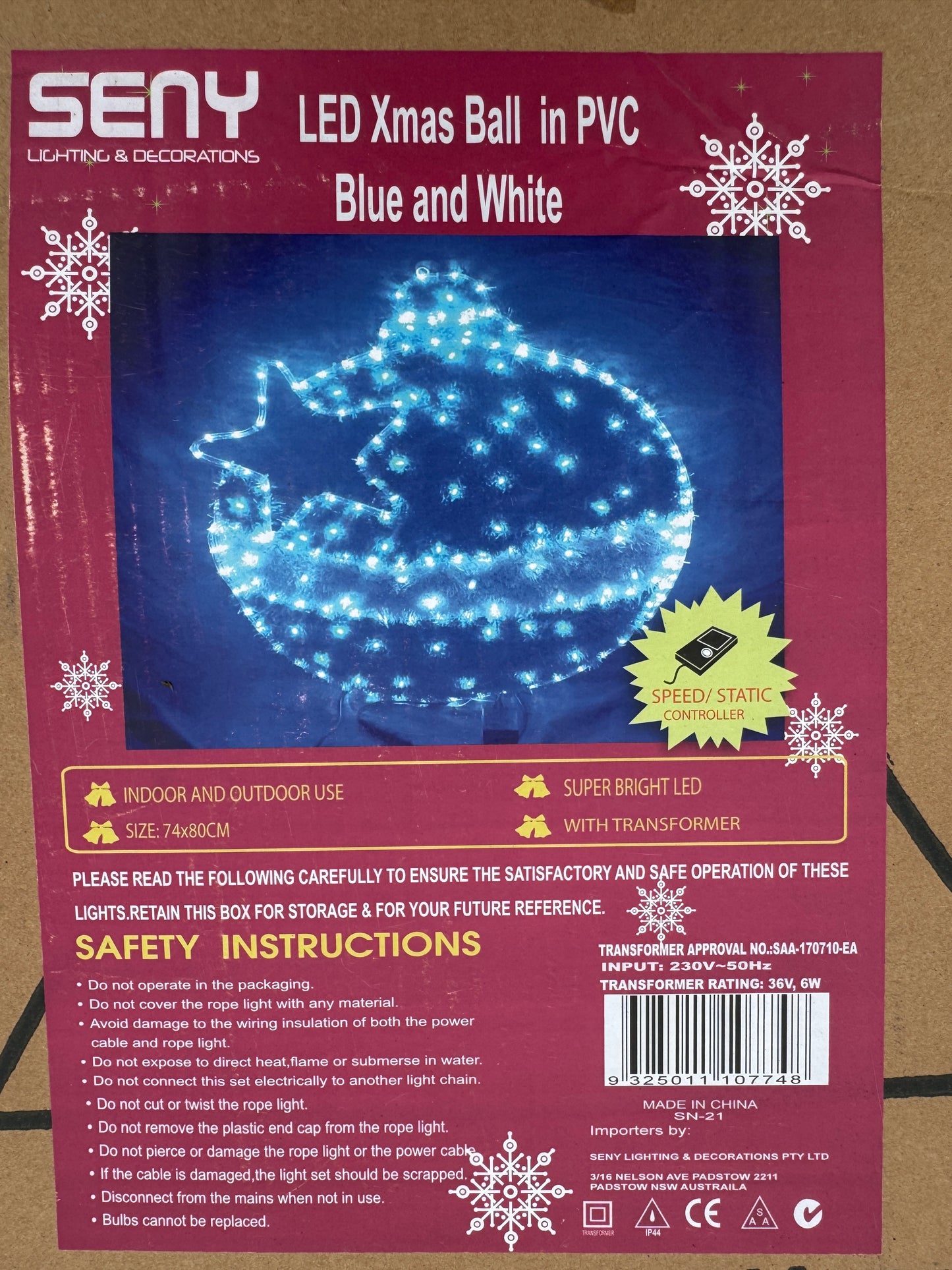Illuminated blue and white bauble-shaped Christmas light with star cut-out design