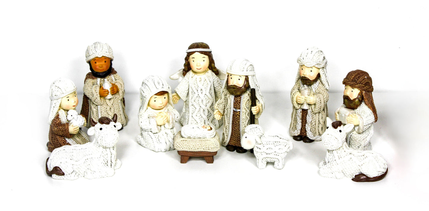 Miniature nativity scene with Mary, Joseph, Baby Jesus, Wise Men, shepherds, and animals in knitted-style detailing