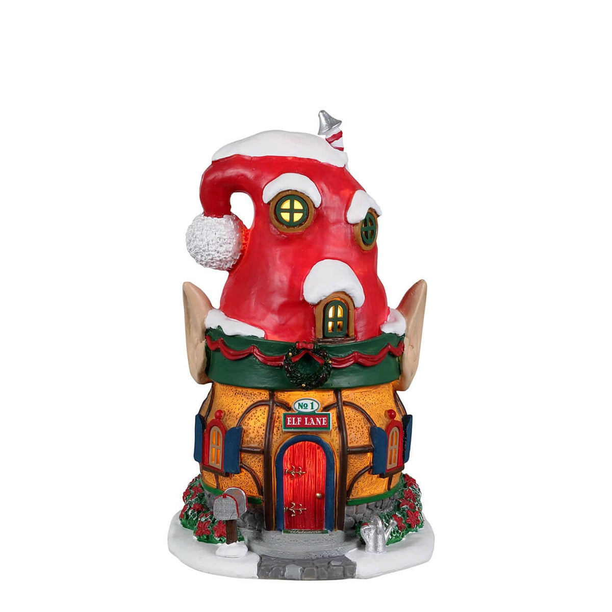 Front view of Lemax Elf Lane house with lit windows, wreath and poinsettia landscaping