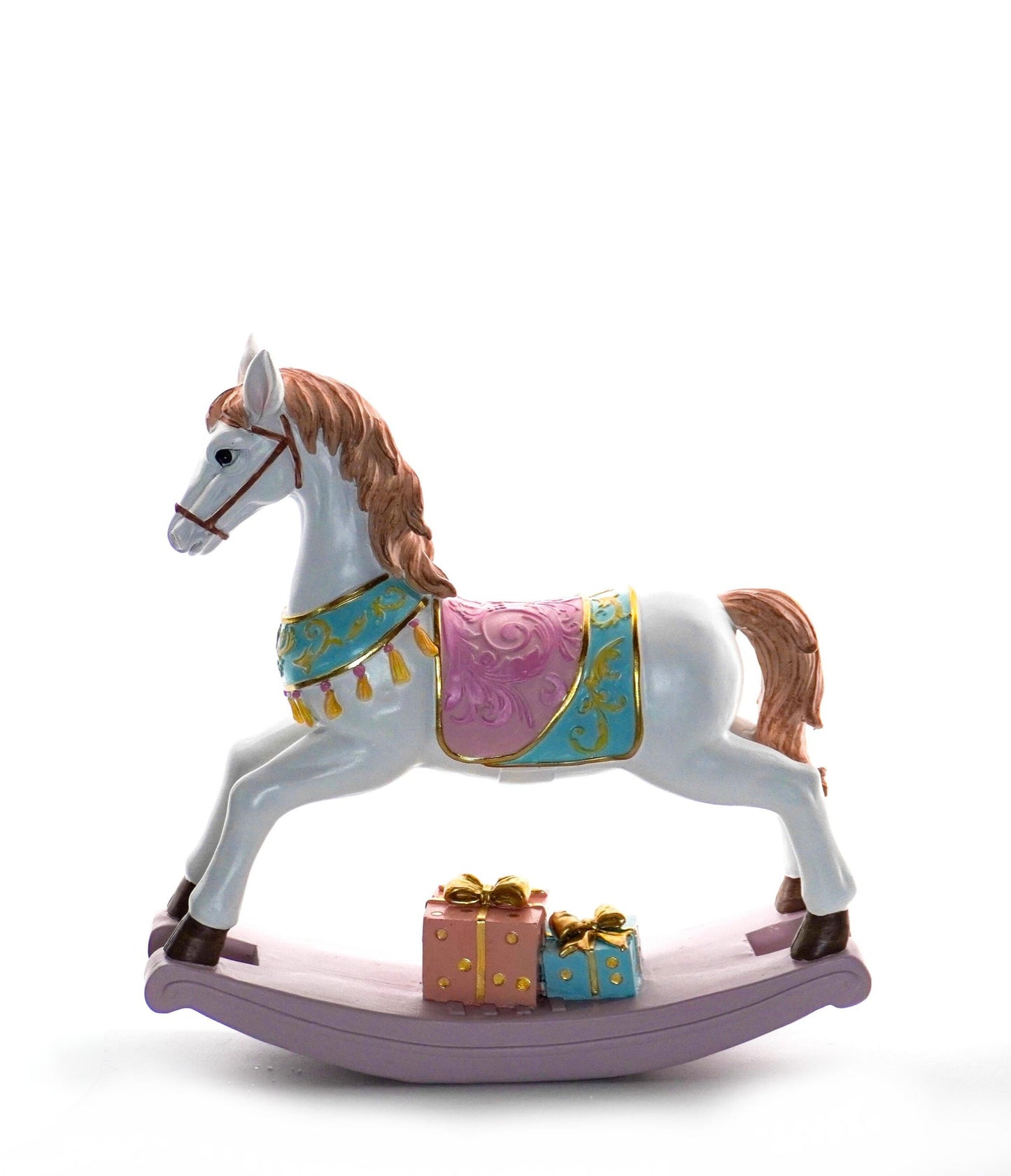 White rocking horse figurine with pastel pink, blue, and gold detailing on a lilac base with presents