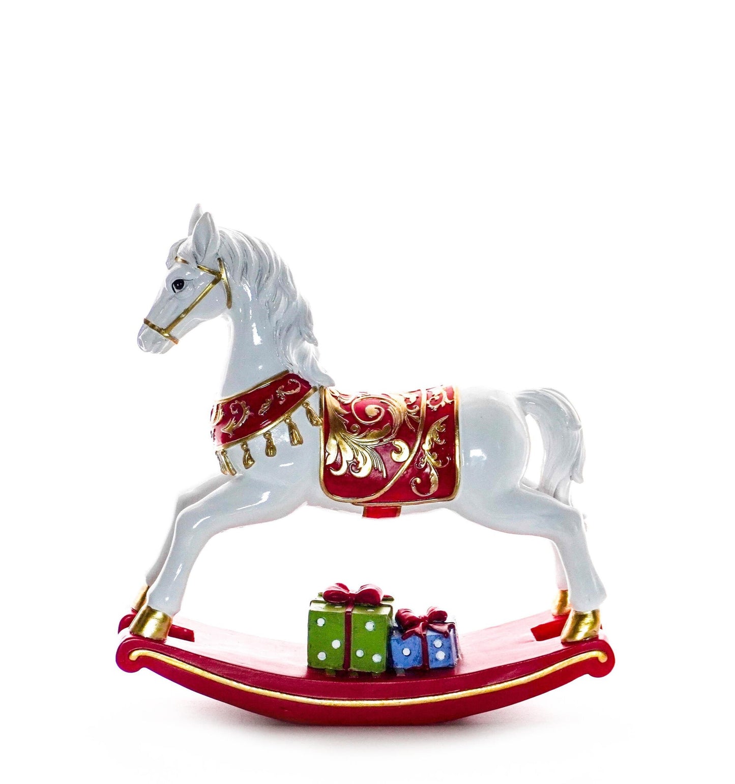 White rocking horse figurine with red and gold saddle on a red base with green and blue presents