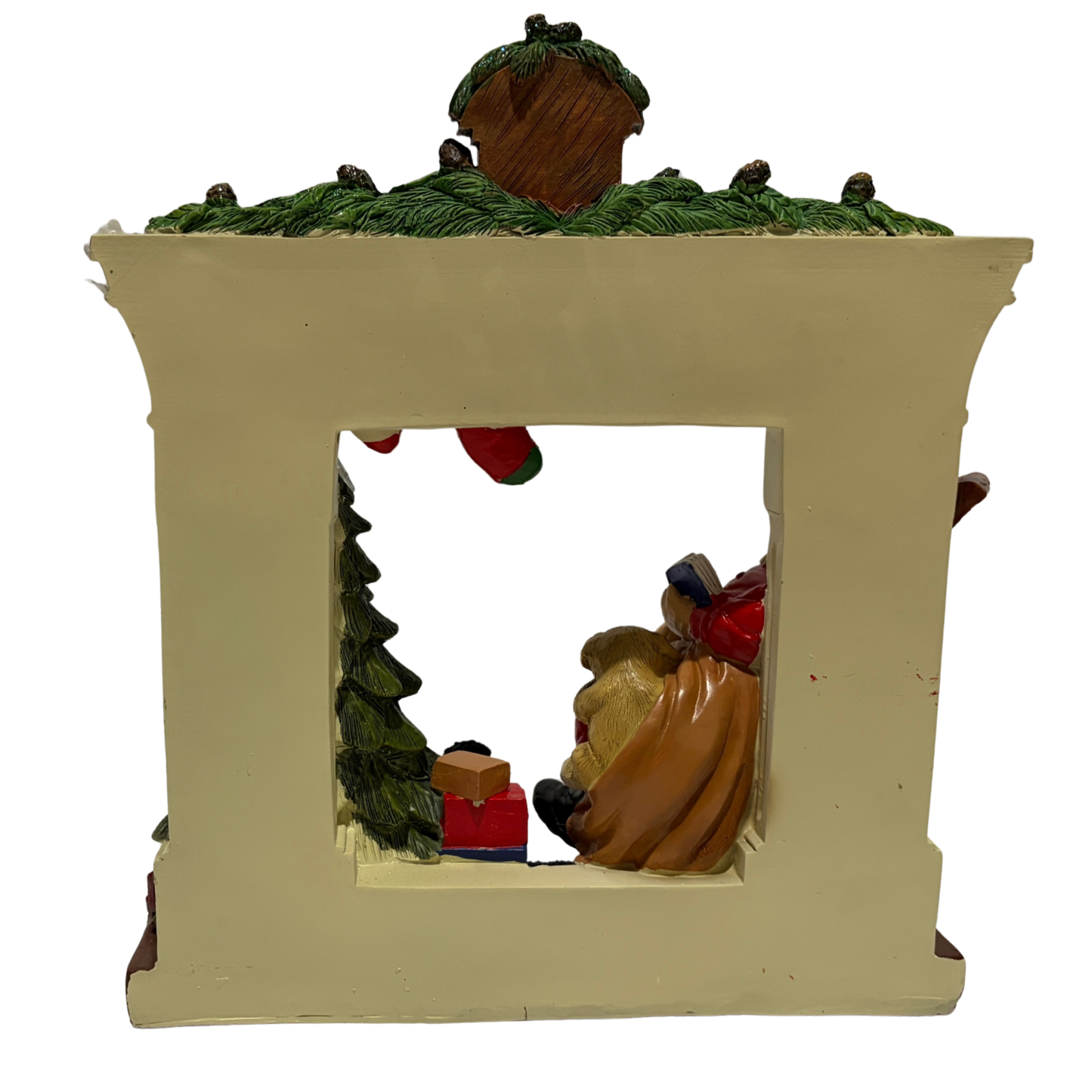 Santa sitting in a rocking chair beside a Christmas tree and fireplace with stockings and a puppy on his lap