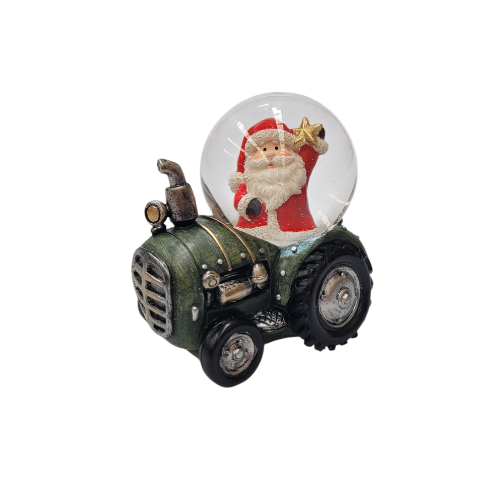 Snow globe with Santa holding a gold star mounted on a green vintage tractor base