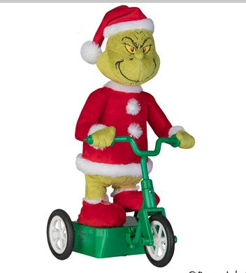 Animated Grinch figurine wearing a Santa outfit and riding a green scooter with a mischievous grin