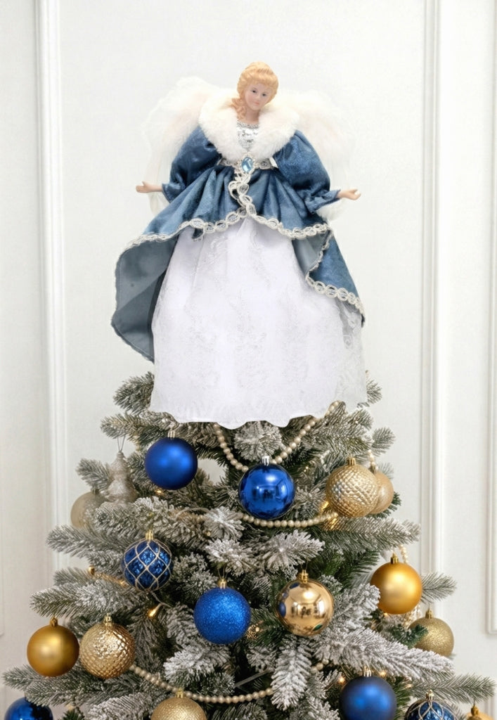 Angel tree topper in blue and white dress with feathered wings on a decorated Christmas tree