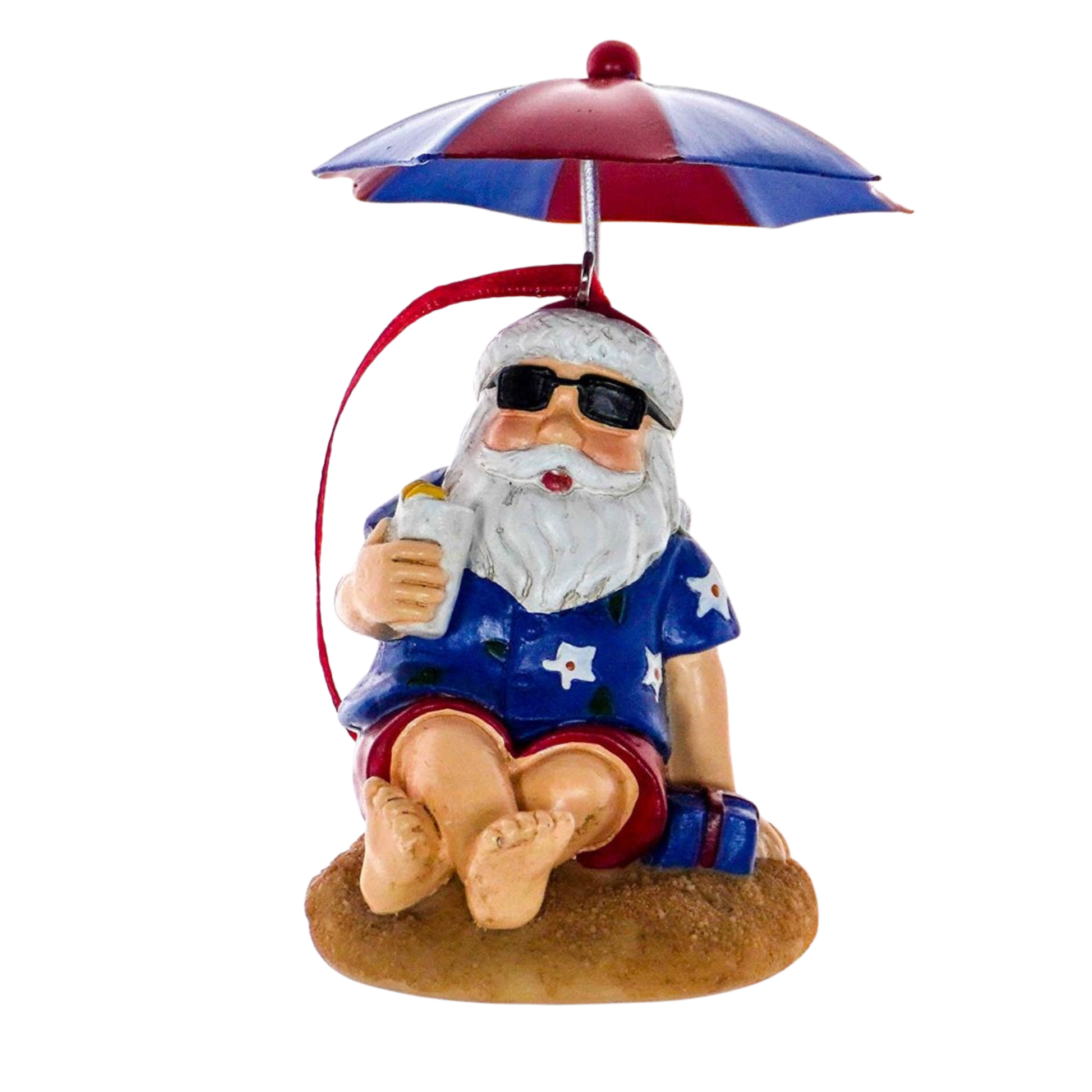 Santa Christmas tree decoration sitting on sand under a striped umbrella in Hawaiian shirt and sunglasses