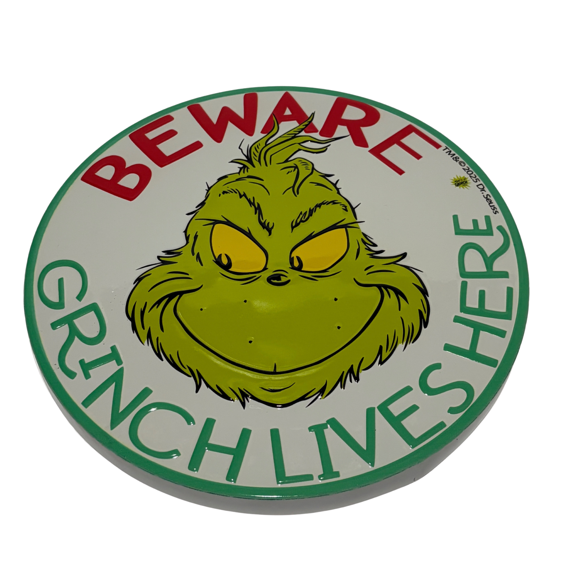 Round sign with the Grinch’s face and red and green text reading “Beware Grinch Lives Here”