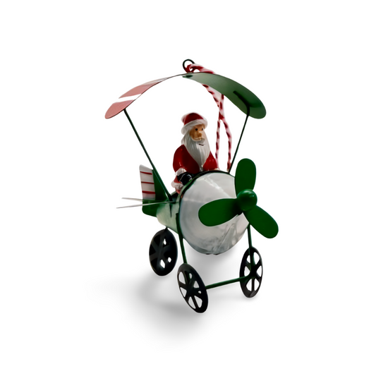 Metal Christmas ornaments shaped like airplanes in red, green, and white, each with a festive character—Santa, snowman, or reindeer—piloting under a striped canopy.