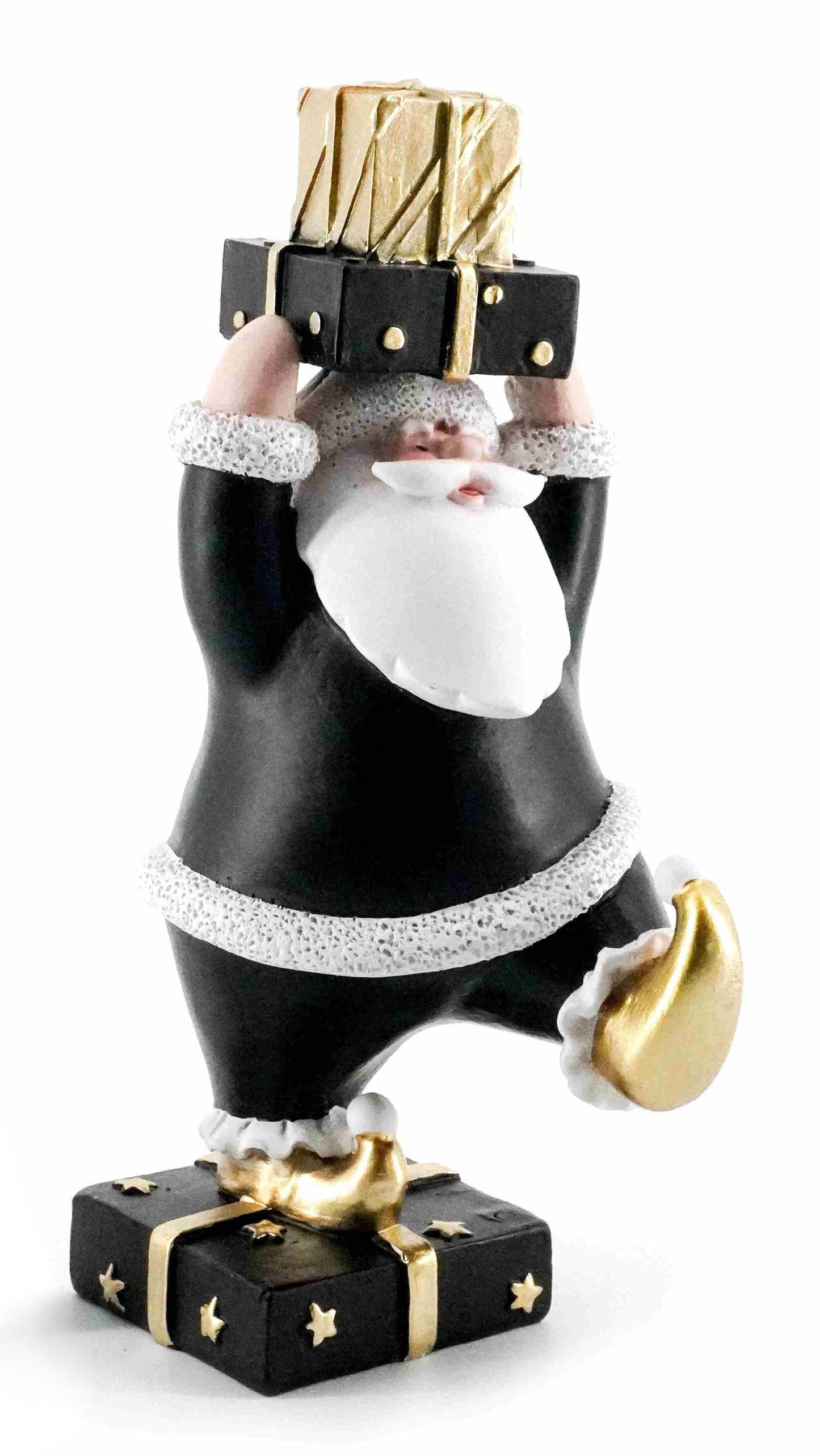 Black and gold Santa figurine holding stacked presents while standing on a black gift box with gold stars