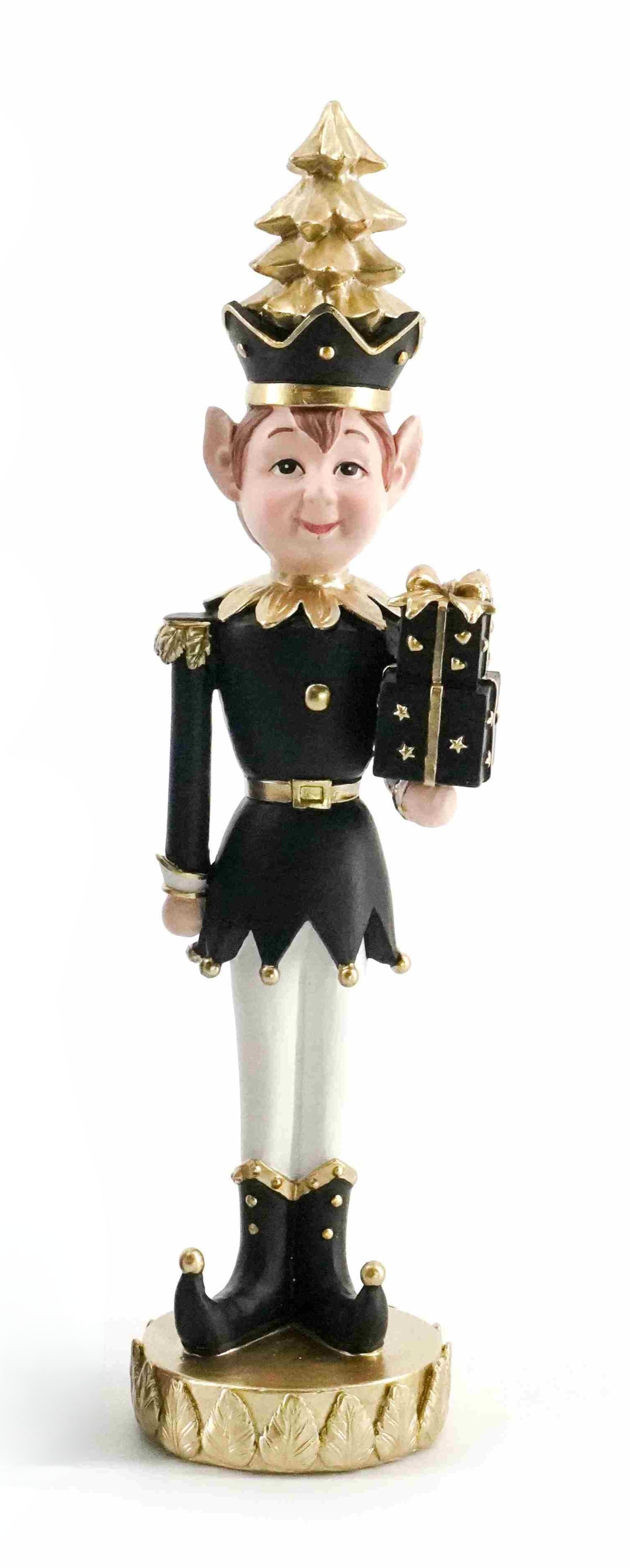 Black and gold elf figurine holding a gift with a gold Christmas tree hat