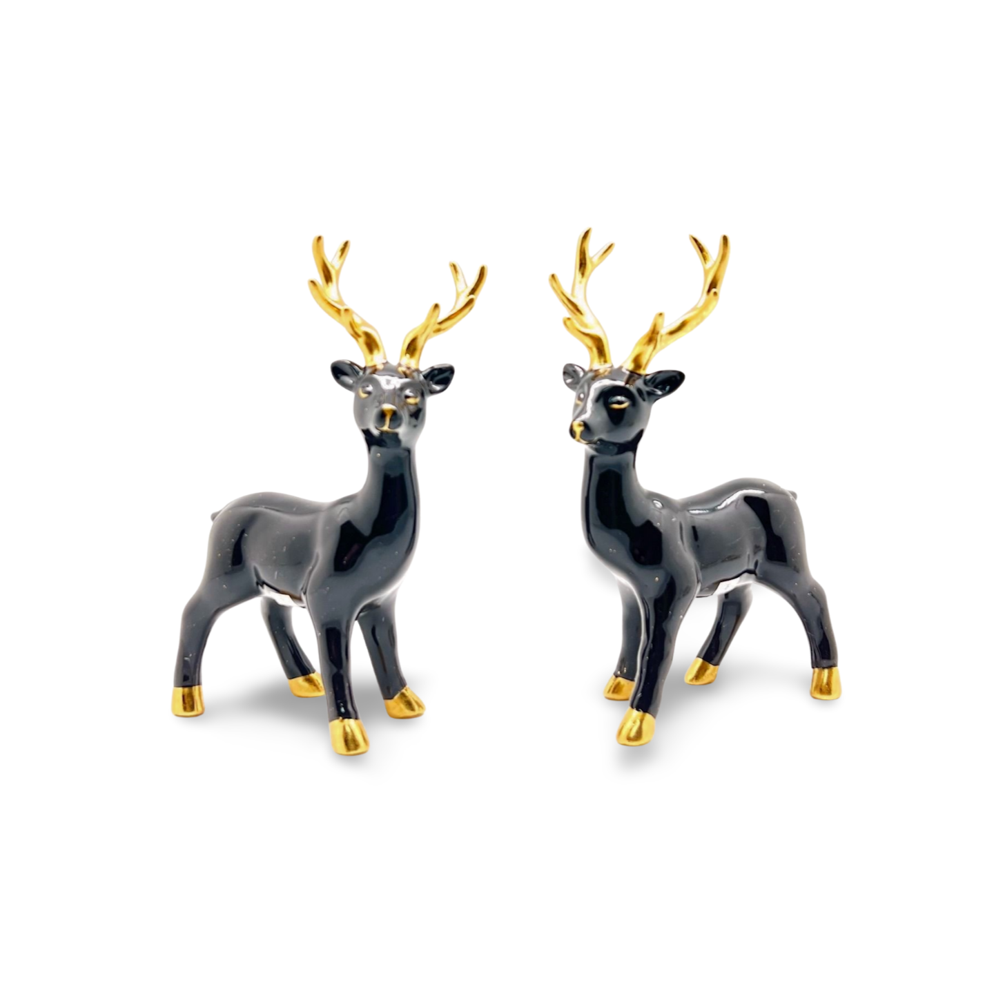 Glossy black ceramic reindeer figurines with gold antlers, hooves and nose, standing on all fours