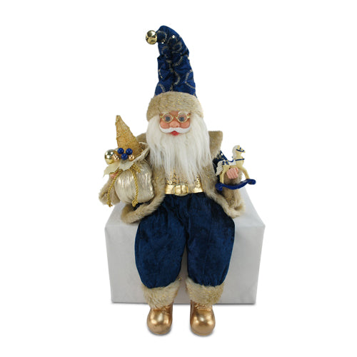 Sitting Santa Claus wearing royal blue with gold accents, holding a sack of presents and a rocking horse