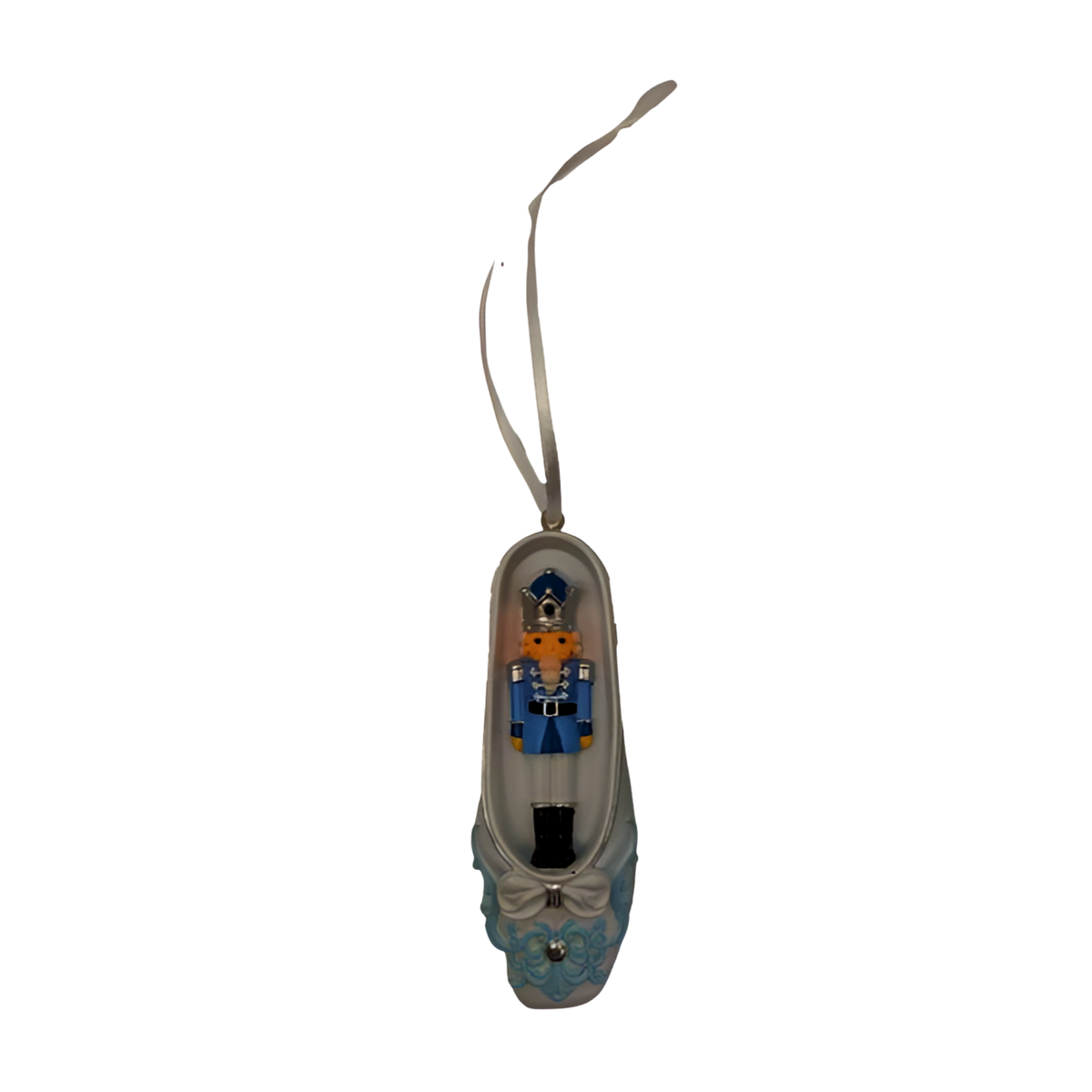 White and blue ballet slipper Christmas ornament with miniature nutcracker soldier figure inside, bow and floral detail, ribbon hanger.