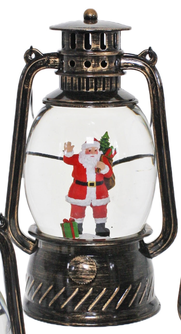 Bronze Christmas lantern snow globe featuring Santa holding a Christmas tree and gifts with swirling glitter.