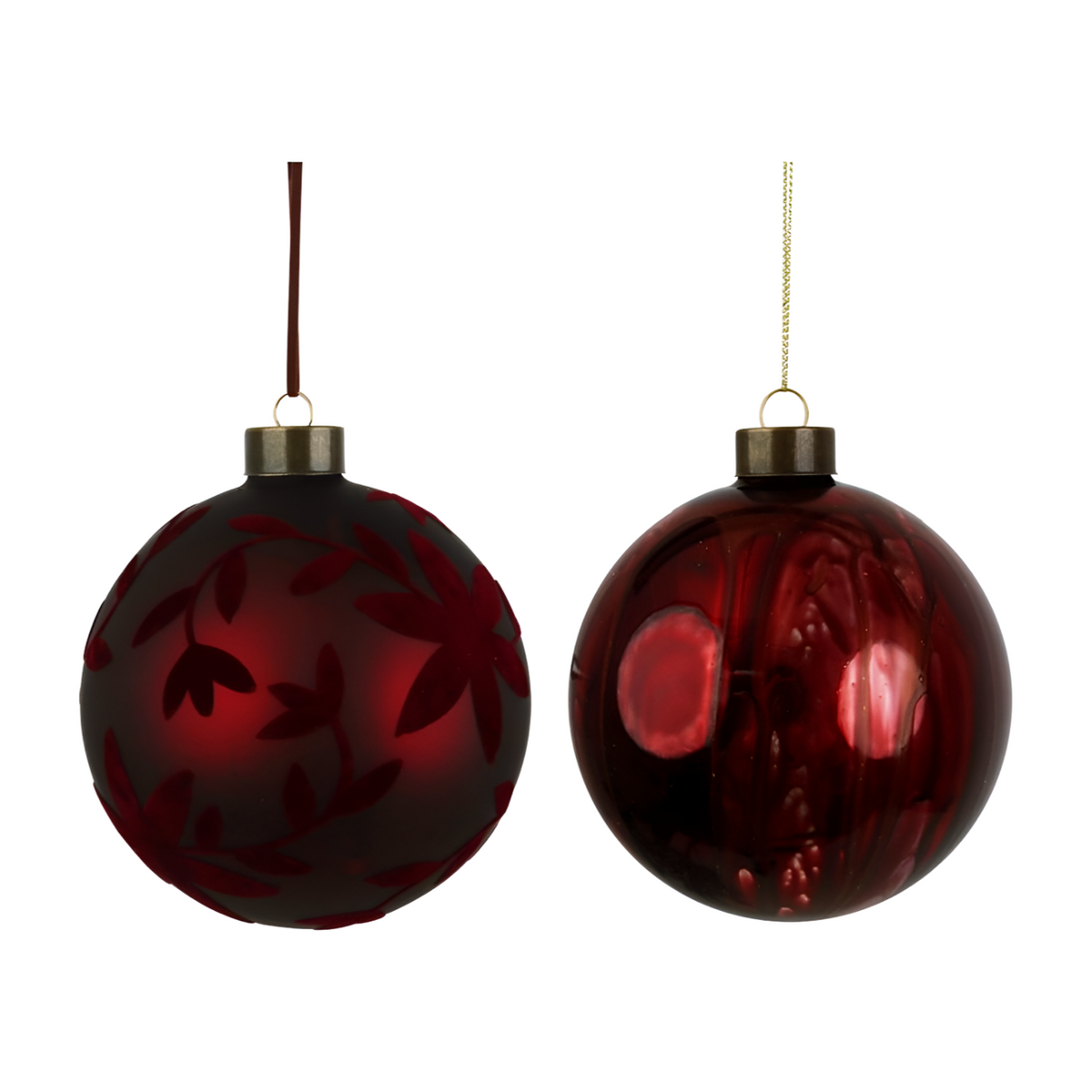Two burgundy glass Christmas baubles — one matte with etched leaf design, one shiny with painted botanical detail