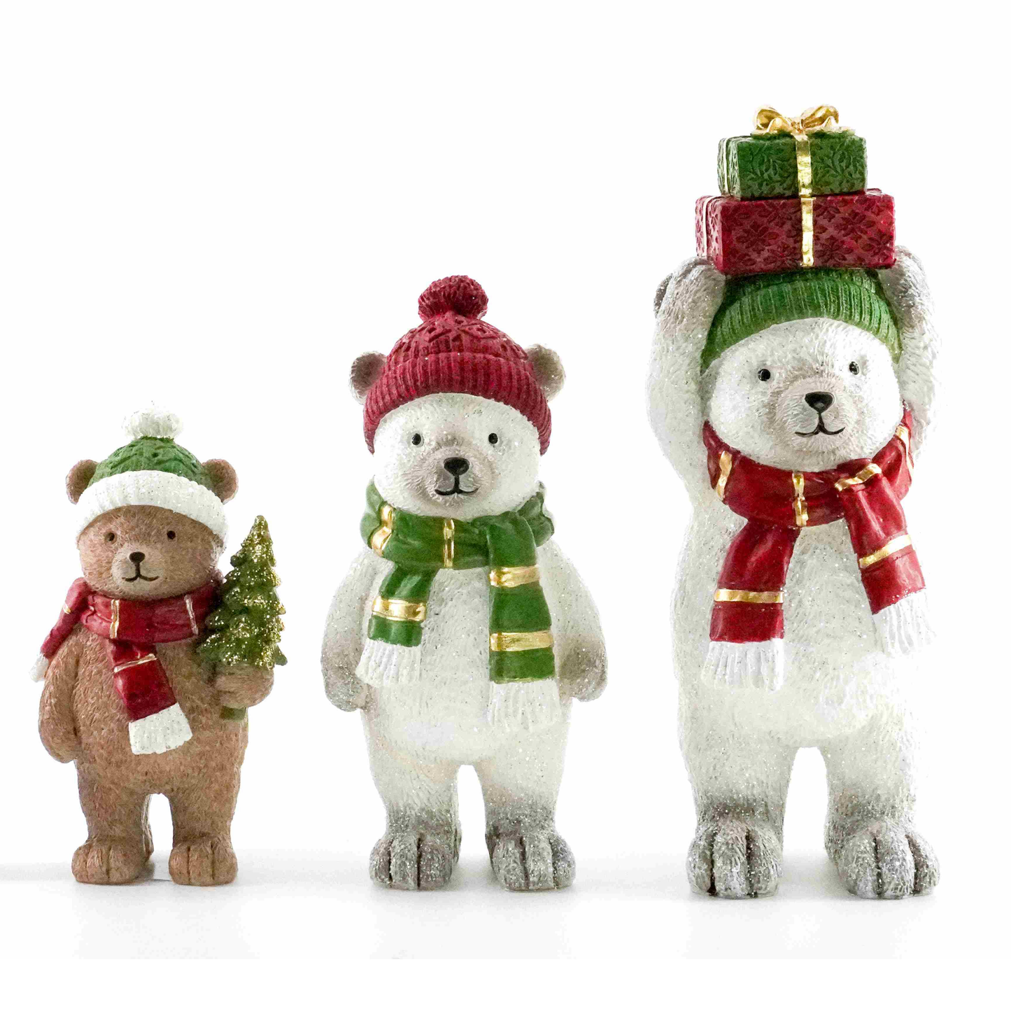 Three Christmas bear figurines — a brown bear with a tree, a polar bear with a green scarf, and a larger polar bear balancing gifts on its head