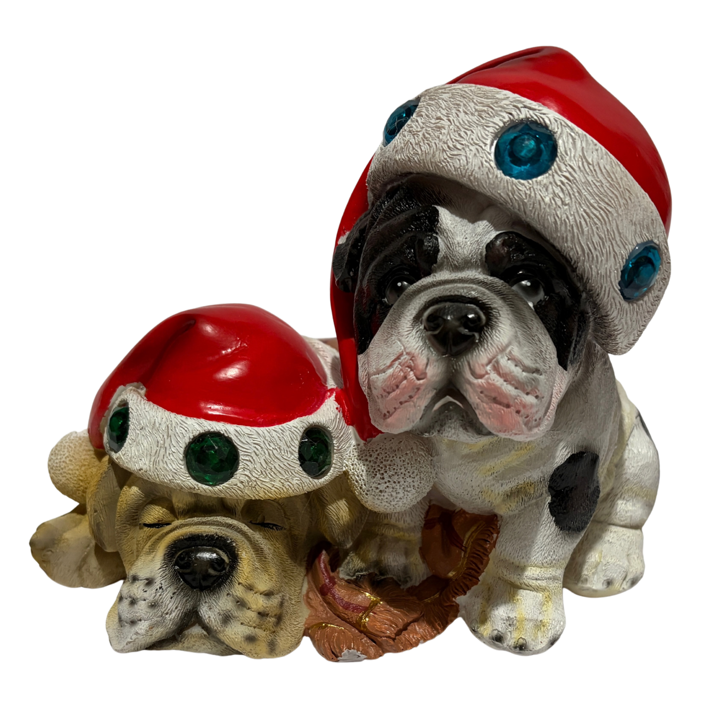 Two bulldogs wearing red Santa hats with colourful jewels, one sitting and one sleeping