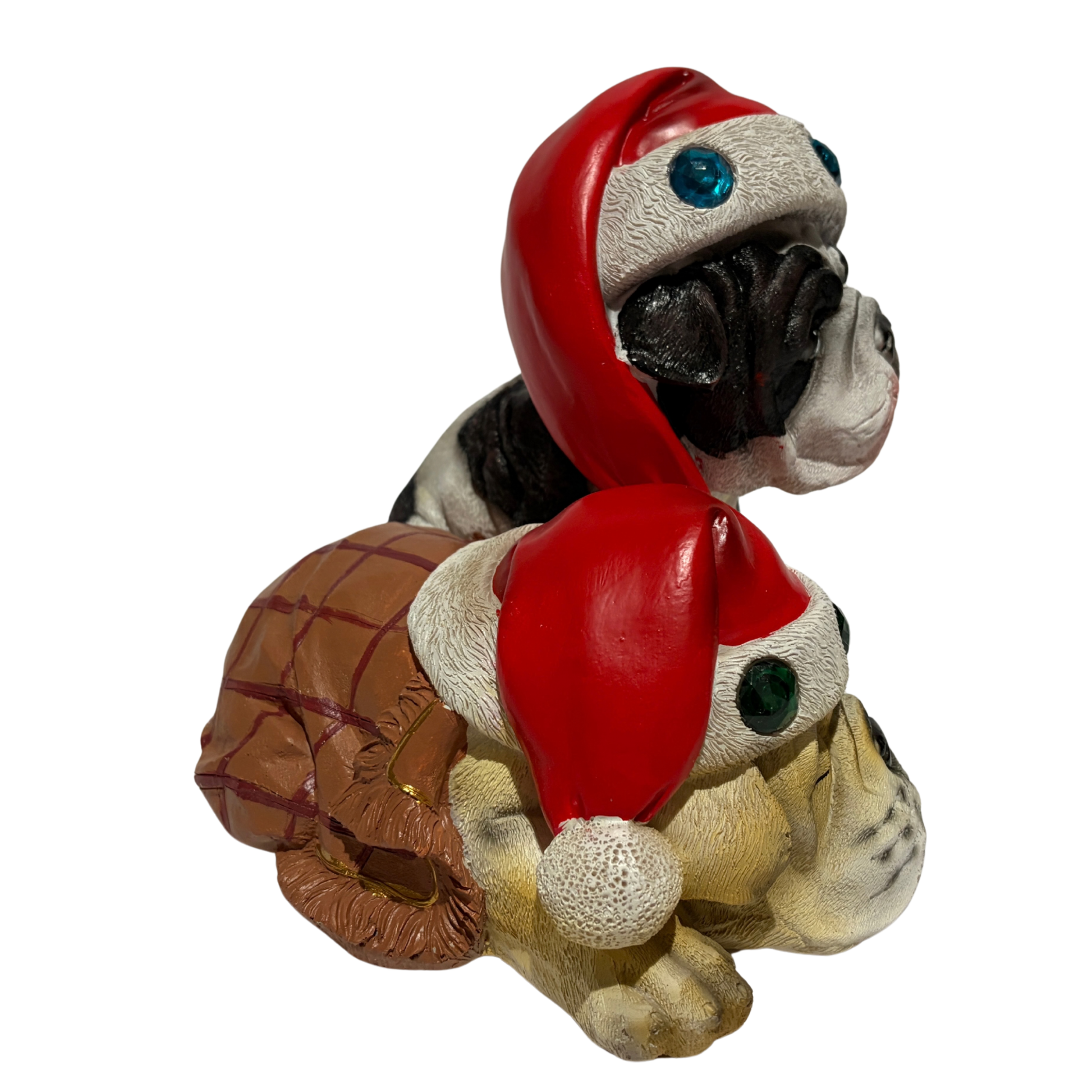 Two bulldogs wearing red Santa hats with colourful jewels, one sitting and one sleeping