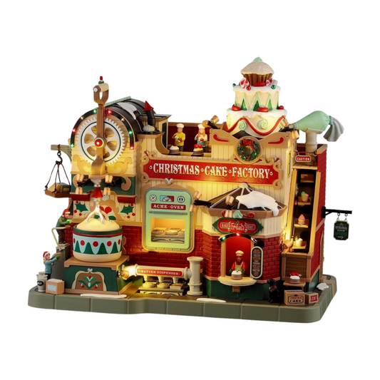 Lit Christmas Cake Factory village building with giant cake topper, working oven, batter dispenser, and detailed baker figurines