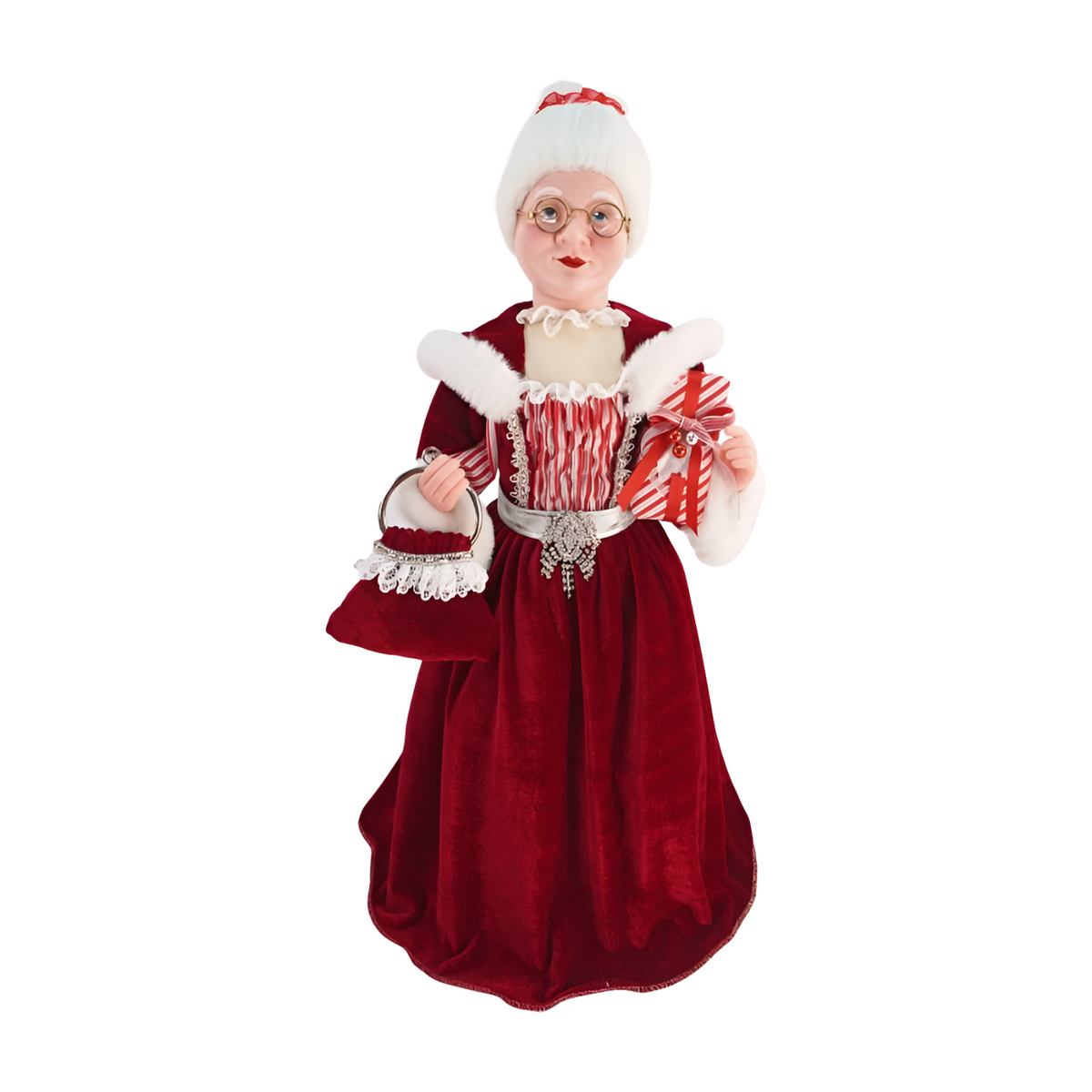Mrs Claus figurine wearing a red velvet dress with white fur trim, holding a striped gift and matching velvet bag