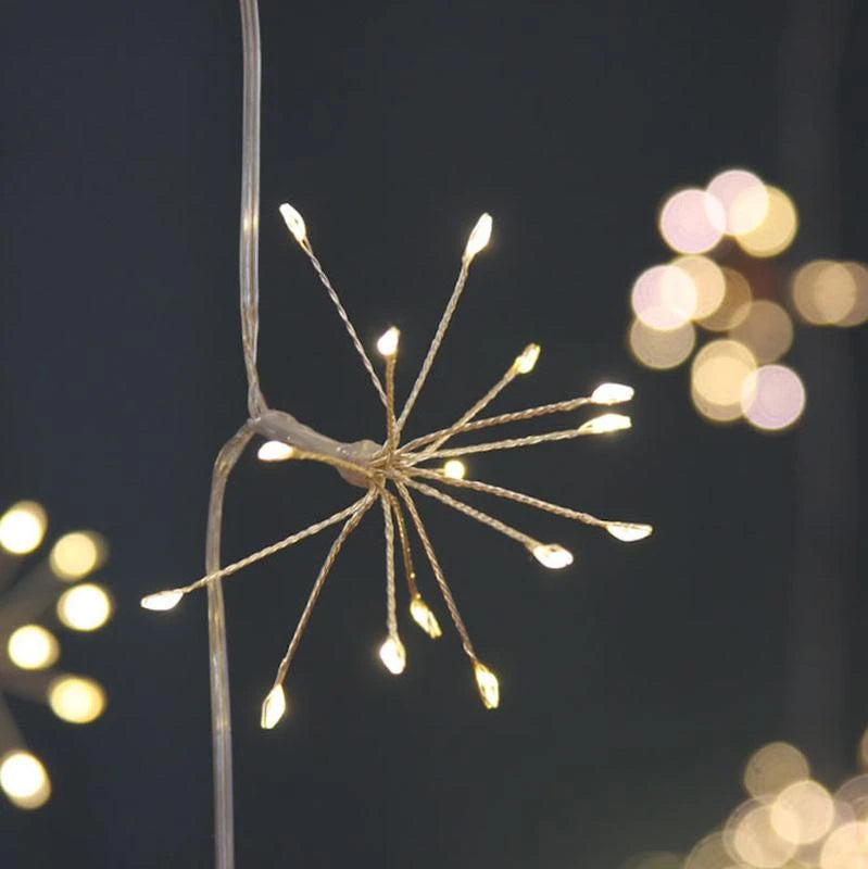 String of starburst LED fairy lights hanging against white wall panelling
