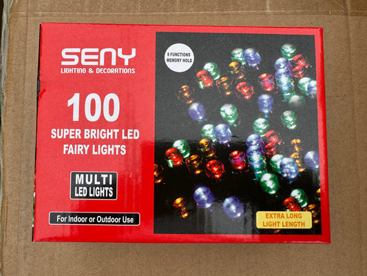 Box of SENY LED fairy lights with colorful bulbs on a brown background