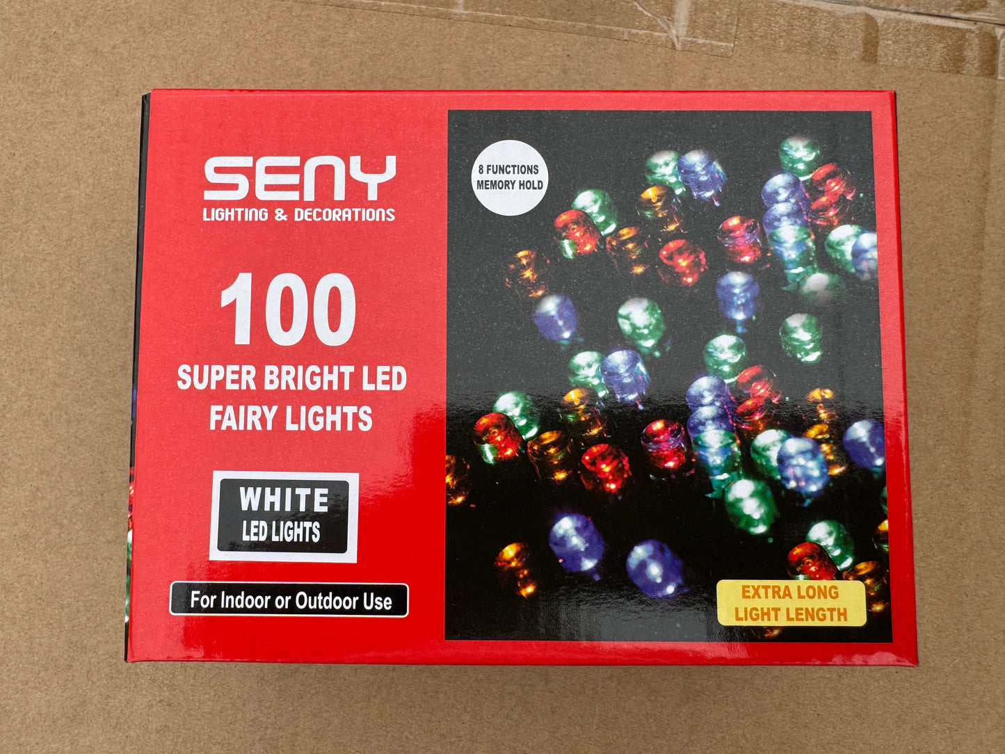 Box of SENY LED fairy lights with colorful lights on a cardboard background