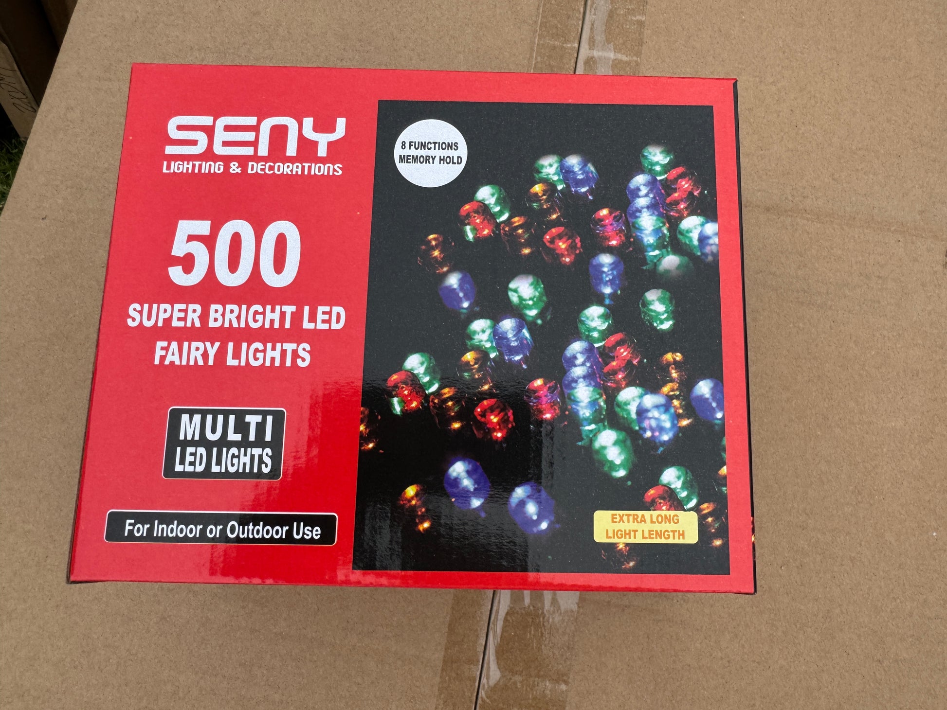 Packaging of LED string lights with colorful bulbs on a cardboard background