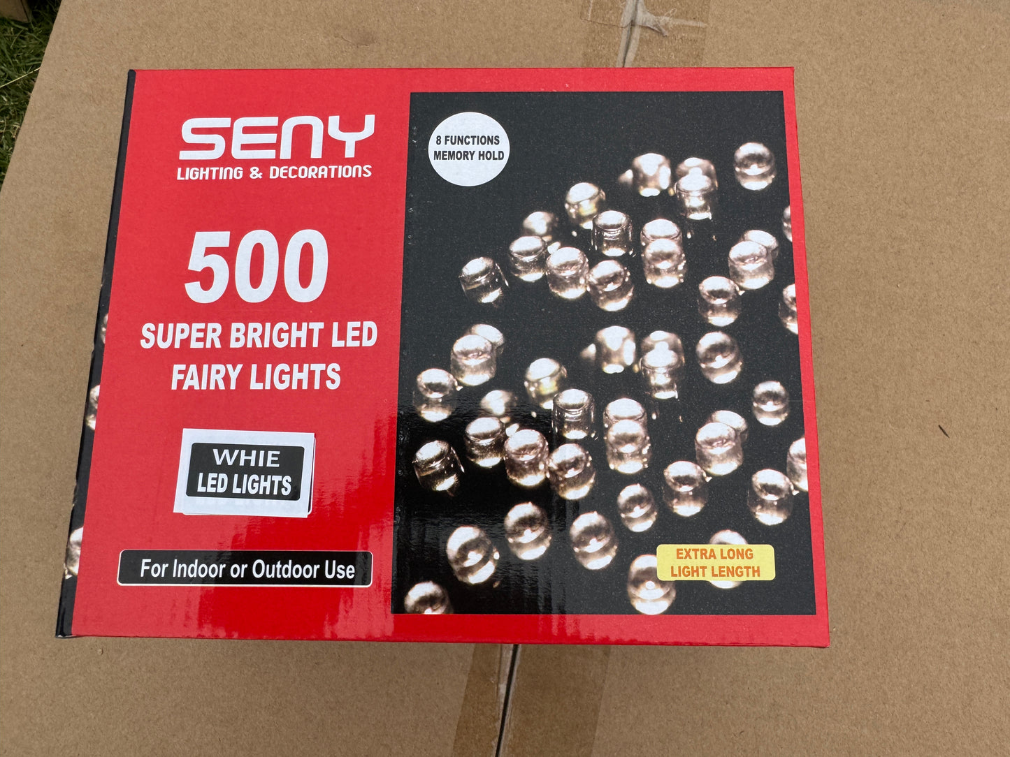Box of LED lights with a red label on a cardboard background
