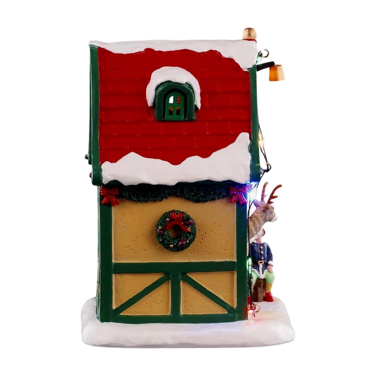 Right view of Cupid's reindeer stable Christmas village building with red and green timber-framed facade, wreath, reindeer, and elf figurine 